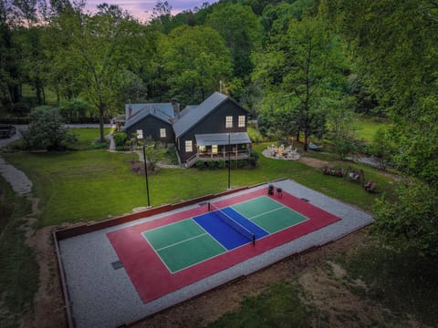 Lighted Pickleball Court with furniture and swings by the creek