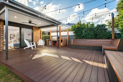 Outdoor entertaining space with deck, furniture, BBQ and drinks fridge. 