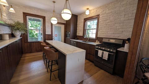 Gather your group around the marble waterfall island for morning coffee