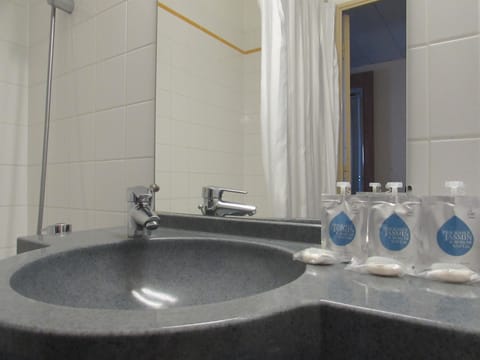 Bathtub, eco-friendly toiletries, hair dryer, towels