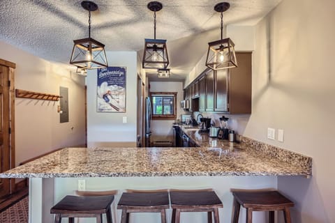 Kitchen bar with seating for four — a great spot for casual meals, drinks, and good conversation.