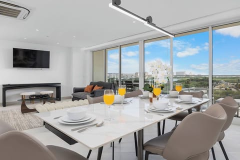 Wake up to fresh orange juice and stunning views from your elegant dining space. Floor-to-ceiling windows frame the scenery while you enjoy breakfast in modern comfort.