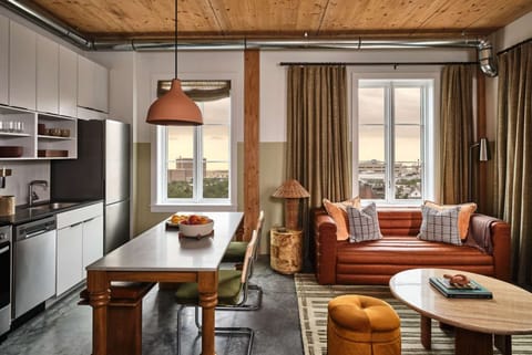 Living and kitchen area with wood table and Sofa.