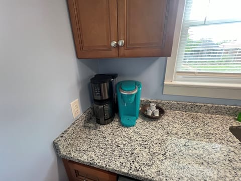 Two coffee makers, one for k-cups and another for a full pot of coffee.