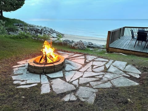 Firepit area set on stone, a cozy spot for evening fires by the lake.