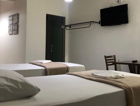 Twin Room, City View | Desk, laptop workspace, blackout drapes, iron/ironing board
