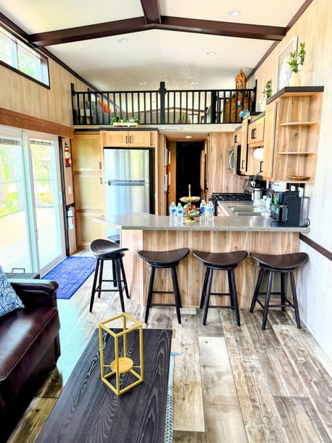 Kitchen with a sliding glass door, connecting the interior space to the tranquil lake setting just outside.