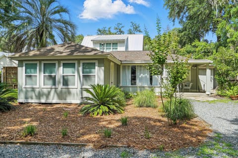 Magnolia Cottage Front Exterior - 412 Magnolia sits inside Pier Village with driveway parking and a covered front entry.