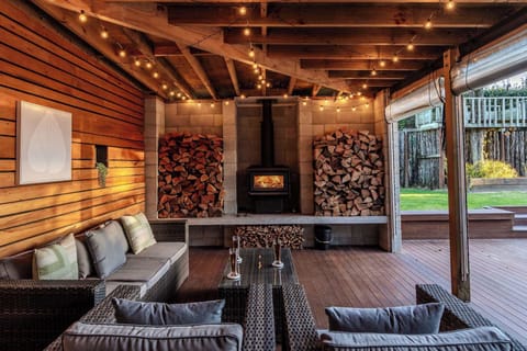 Amazing outdoor area with it's own fireplace, comfy chairs and drop down curtains to keep the heat in during the colder months.