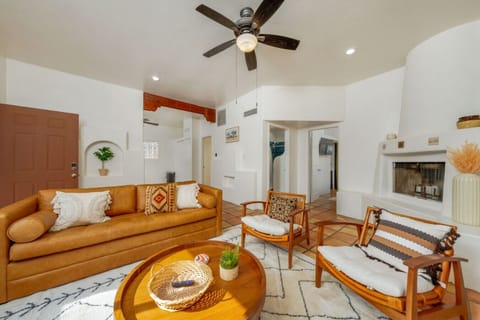 HOUSE: Bright, stylish living room with queen-size sofa bed, seating, and beehive fireplace (nonfunctional)
