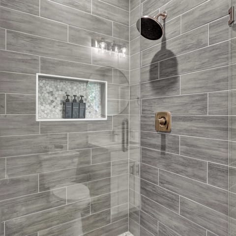 Step into this Luxurious Shower Oasis: Experience modern elegance with a spacious walk-in shower and chic finishes!
