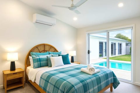Second bedroom with queen bed, air conditioning and pool outlook
