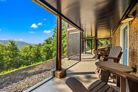 With uninterrupted forest views and cozy seating, this lower-level retreat is made for lazy afternoons and golden sunsets.