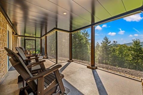 Grab a seat, breathe in the fresh mountain air, and enjoy the peace and quiet from this spacious screened-in patio.