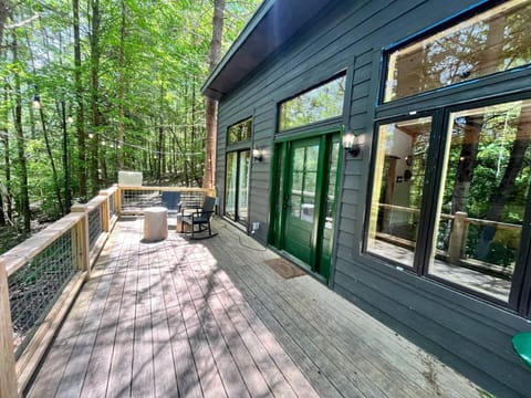 Spacious wooden deck surrounded by trees and nature.