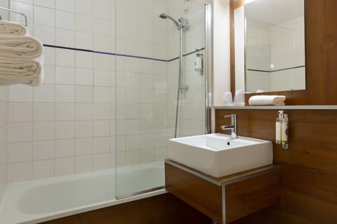 Bathtub, eco-friendly toiletries, hair dryer, towels