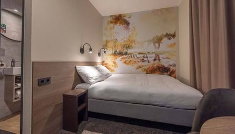 Sink into a cozy double bed under warm reading lights.