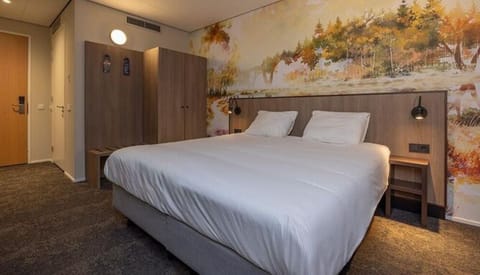 Unwind on crisp linens beneath a calming forest mural.