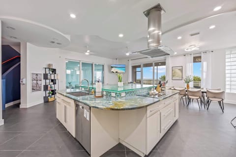 Modern kitchen with a large island and ocean views through sliding glass doors