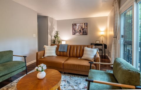 Spacious and stylish living room with plush seating and plenty of natural light.