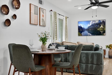 Living Room | With a plush emerald sofa, sleek Smart TV, warm wood accents, and 