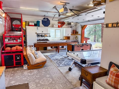 The garage has been transformed into a fun-filled game room featuring Hoop Fever, shuffleboard, air hockey, and foosball. Plus, it's fully heated for year-round enjoyment. In the summer, open up the garage and enjoy the fresh air!