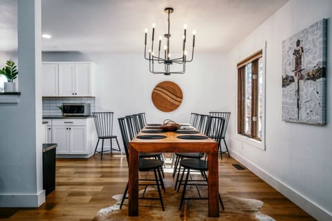 Large dining table with seating for 8 plus more seating in living room bar area.