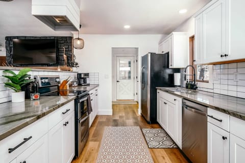 Stylish kitchen with fully stocked cooking and serving essentials.