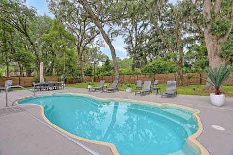 Enjoy your own slice of paradise with this lush backyard. Equipped with lounge chairs and a luxury BBQ grill, this yard creates the perfect getaway. 