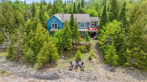 A private, tree-lined retreat just steps from Myles Bay, offering the perfect blend of seclusion and lake access.