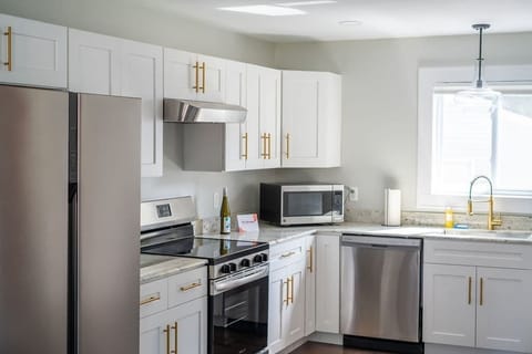 Kitchen- Sleek appliances, bright light, and everything you need to cook in.