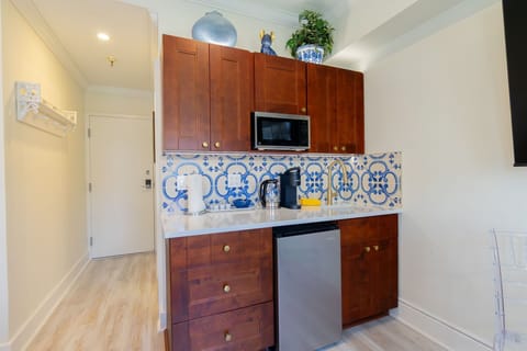 Kitchenette/wet bar. Keurig machine, cups, plates, flatware, microwave, fridge. 
