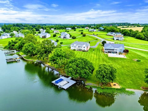 Aerial View - 220 feet of deep-water shoreline, a private two-slip dock, and a sweeping green lawn set the stage for lakefront living at its best.