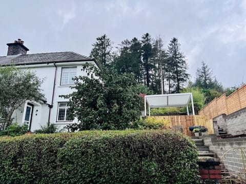 Taf Fechan exterior, with two tier garden and pergola.