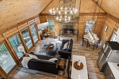 The open living space has loads of natural light and a stunning river rock fireplace