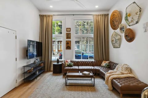 Living Room Suite 101 | Open concept lounge with comfortable seating TV and natural light designed for relaxing after exploring the city