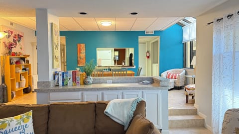 View of living room and dining area, through to the kitchen.