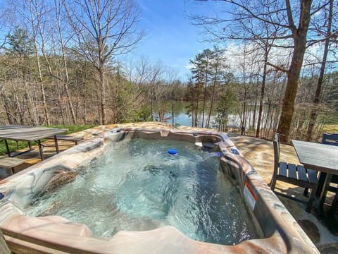 Unwind in the soothing warmth of the hot tub while enjoying the stunning lakeside views, or gather around the outdoor dining area for a meal with a backdrop of nature's beauty. 