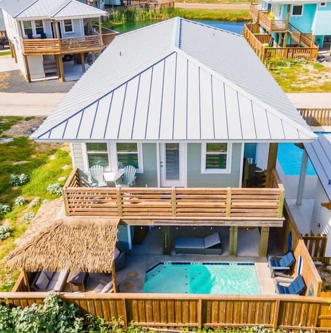 Take it all in! This stunning aerial view showcases your private retreat — a beautiful home paired with a sparkling pool, inviting you to relax, play, and soak up the sunshine.