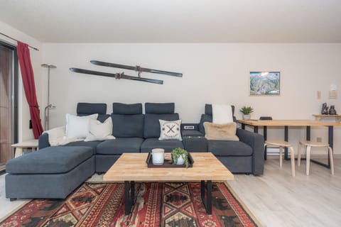 Relax in your cozy living space with plush sectional seating and alpine charm—vintage skis add character to your mountain getaway.
