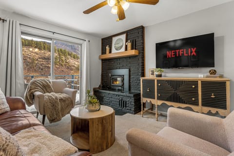 - Cozy up in the inviting living room featuring a modern black brick fireplace and soft seating
- Enjoy your favorite shows on the large screen with built in Netflix
- Sliding doors open to mountain views and fresh alpine air