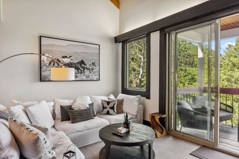 Elegant living room with beautiful views, fireplace, and large smart TV