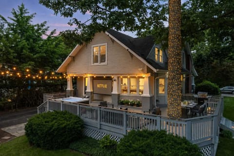 Outdoor Entertainment Oasis: Enjoy movie nights under the string lights and stars on the expansive outdoor deck, featuring a 100" projector screen, 7-person luxury hot tub, fire-pit, and plenty of outdoor seating for the whole group.
