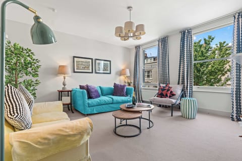 Bright and beautifully furnished with colourful, unique pieces, this light and airy living room boasts the perfect London residential view. Enjoy plenty of space to relax, ample seating, and a smart TV for cosy evenings in.