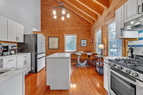 - Spacious kitchen and dining layout with wood beams   - Cook, dine, and connect in bright open concept   - Perfect for family gatherings after outdoor fun