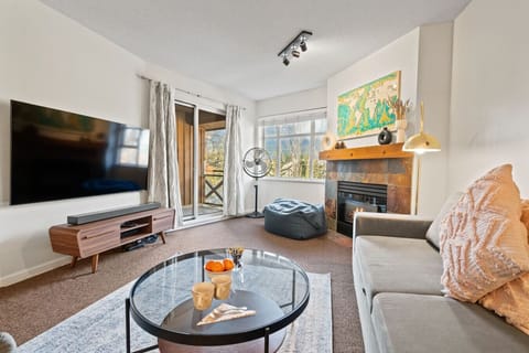 Living room featuring a cozy gas fireplace and breathtaking mountain views.