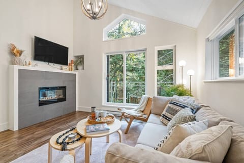 Living area with electric fireplace and balcony access, modern and inviting.