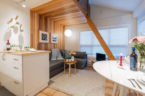 Cozy living area with comfy sofa and warm modern wood finishes