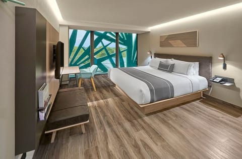 Unwind in a sleek king bed with dramatic window views.