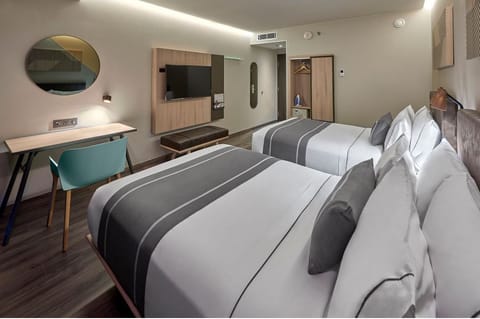 Settle in with cozy beds, smart TV, and work desk.